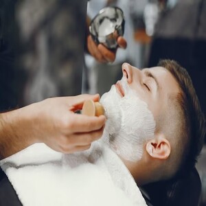 man-cuts-his-beard-barbershop_1157-16053