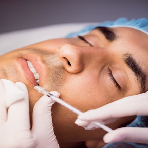 man-receiving-botox-injection-his-lips_107420-65192