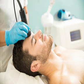 profile-view-good-looking-young-man-getting-rf-facial-treatment-health-spa_662251-2575